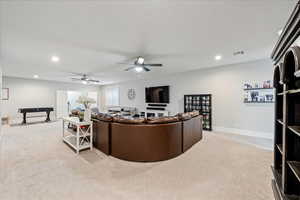 Living room with light colored carpet, recessed lighting, a ceiling fan, baseboards, and billiards