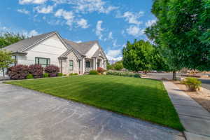 View of front facade with a front yard and stucco siding