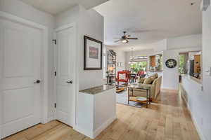 Hallway featuring light wood finished floors and baseboards