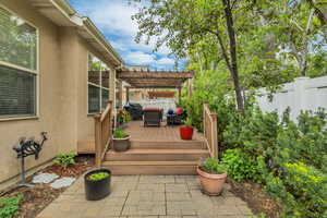 Wooden deck with a pergola, a fenced backyard, and grilling area