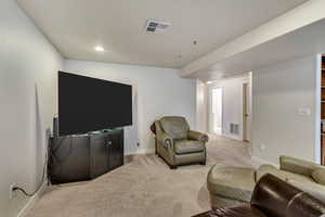 Living room featuring light carpet, baseboards, and recessed lighting