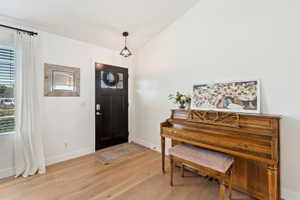 Entrance foyer featuring light wood-style floors and baseboards