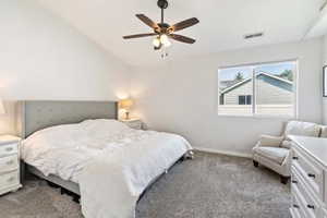Bedroom featuring carpet, baseboards, lofted ceiling, and ceiling fan