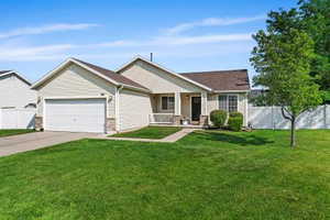 Ranch-style home featuring a garage, concrete driveway, and covered porch