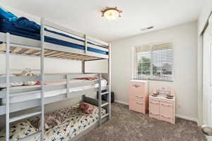 Bedroom featuring carpet and baseboards