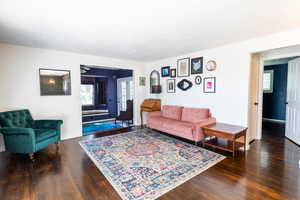 Living area with wood finished floors, baseboards, and a ceiling fan