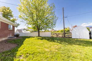 View of yard with a storage shed and an outdoor structure