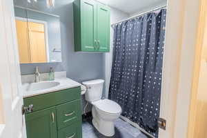 Bathroom with tile patterned flooring, toilet, vanity, and a shower with curtain