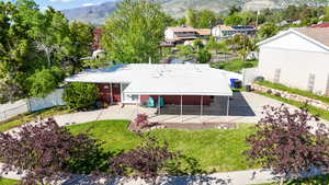 Aerial view of property and surrounding area featuring a mountainous background