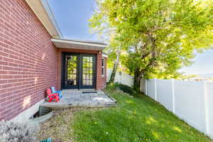 View of exterior entry with brick siding