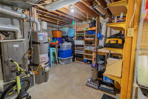 Unfinished below grade area featuring strapped water heater