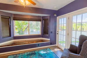 Bathroom featuring baseboards, healthy amount of natural light, and wood finished floors