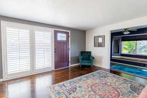 Foyer entrance with wood finished floors and baseboards