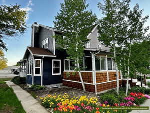 View of home's exterior with a sunroom and a chimney