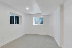 Carpeted empty room featuring baseboards, healthy amount of natural light, and recessed lighting