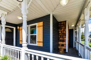 Entrance to property featuring covered porch