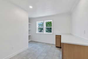 Unfurnished room with ornamental molding, light tile patterned flooring, recessed lighting, and baseboards