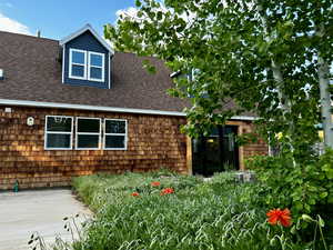 View of front of property with a shingled roof