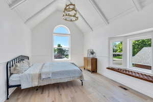 Primary bedroom with wood finished floors and baseboards