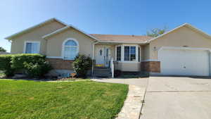Ranch-style house with brick and stucco  and concrete driveway