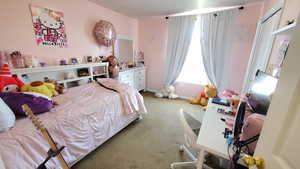 Carpeted bedroom featuring baseboards