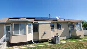 View of property exterior featuring solar panels