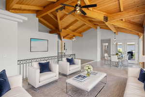 Living room with wooden ceiling, ceiling fan, and french doors
