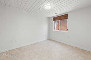 Spare room with baseboards and carpet