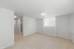 Below grade area with baseboards and carpet floors