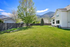 View of yard with a mountain view and central AC unit