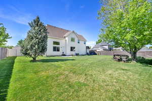 Rear view of property with roof with shingles