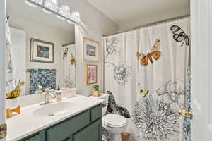 Full bath with toilet and vanity