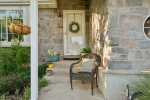 Doorway to property with stone siding