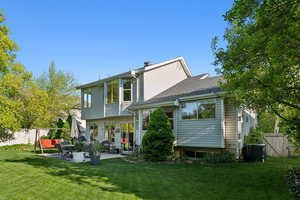 Rear view of house with a patio, central air condition unit, and a shingled roof