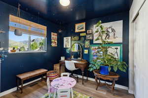 Home office with wood finished floors and baseboards