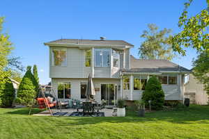 Rear view of property with a patio area and roof with shingles