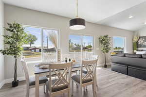 Dining space with light wood-type flooring, baseboards, plenty of natural light, and recessed lighting