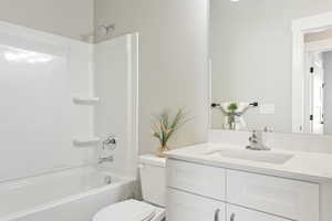 Bathroom with toilet, vanity, and bathing tub / shower combination