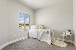 Carpeted bedroom with baseboards