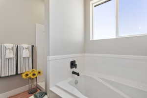 Full bathroom featuring a bath