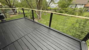 Wooden deck featuring a lawn