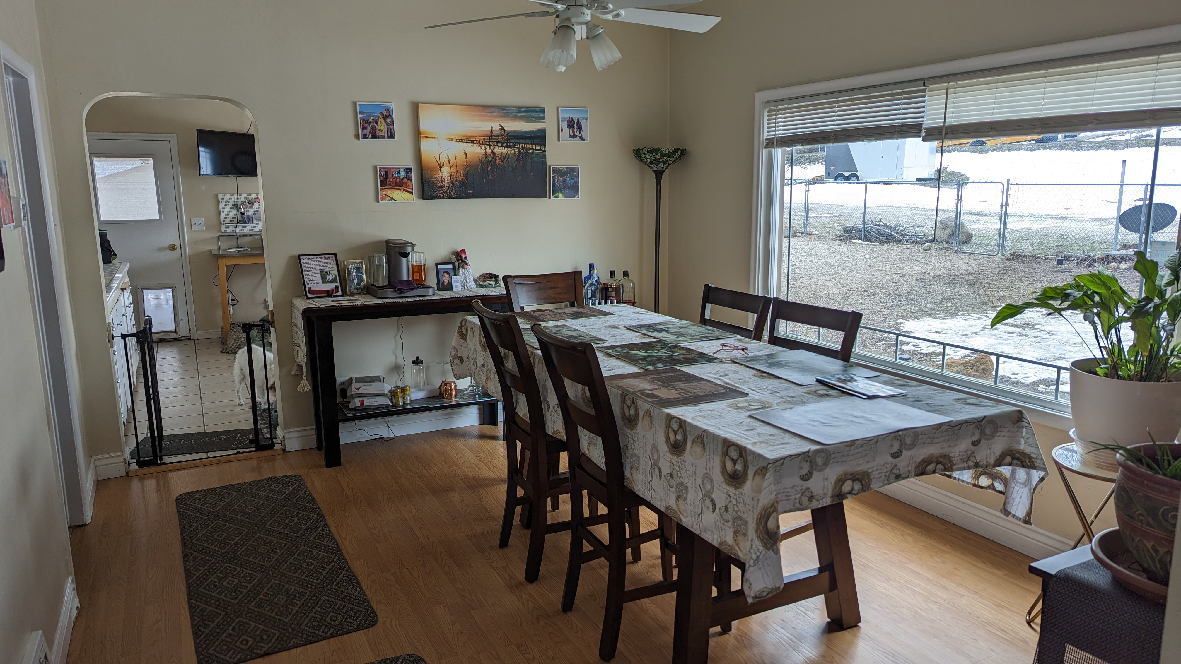 Dining room with arched walkways, a ceiling fan, wood finished floors, and a wealth of natural light