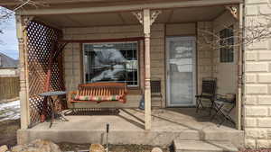 View of patio / terrace featuring a porch and fence
