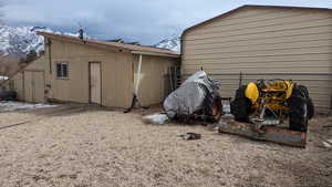 View of outbuilding with fence