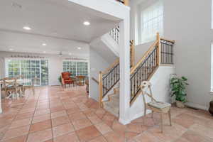 Staircase featuring a ceiling fan, recessed lighting, baseboards, and tile patterned floors