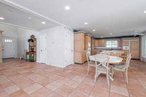 Dining room with recessed lighting, light tile patterned floors, baseboards, and a ceiling fan
