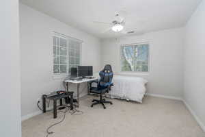 Carpeted office featuring baseboards and ceiling fan