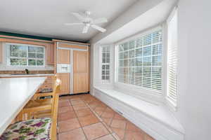 Kitchen featuring light countertops, a sink, light tile patterned floors, and plenty of natural light