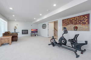 Exercise area with carpet flooring, recessed lighting, and baseboards