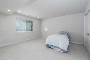 Bedroom with carpet, recessed lighting, baseboards, and a closet